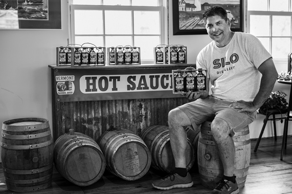 

Floyd Carruth Jr. shows off a display of his Vermont Barrel Aged hot sauces, which he prepares for retail sale in the commercial kitchen at Mach’s General Store in Pawlet, Vt. Joan K. Lentini photo