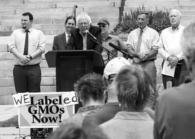 U.S. Sen. Bernie Sanders, I-Vt., joined other elected officials and activists on July 1 to celebrate the start of Vermont’s new law requiring labeling of genetically modified foods. The achievement would prove short-lived, as Congress voted later in July to nullify the Vermont law and any others like it. Roger Crowley photo/courtesy Vermont Public Interest Research Group