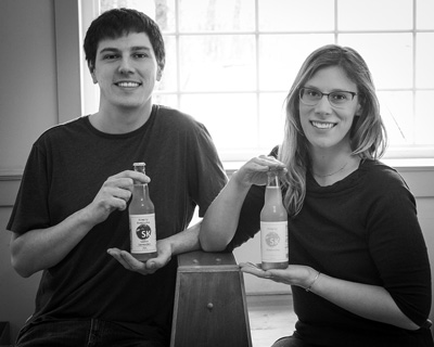 Ryan and Jennifer Bremser hold bottles of Simply Kombucha, the beverage they now produce commercially in Hudson Falls. The Bremsers started making the slightly fermented tea for themselves two years ago as Jennifer underwent cancer treatment, and the project grew into a business. Joan K. Lentini photo