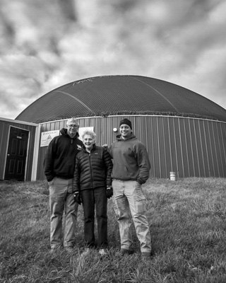 Three generations of the Wagner family -- Peter, Louise and Keith Wagner -- stand in front of the anaerobic biodigester at their dairy farm in Brunswick, N.Y. The device converts cow manure and other agricultural wastes into methane that can be burned for heat and power. Joan K. Lentini photo