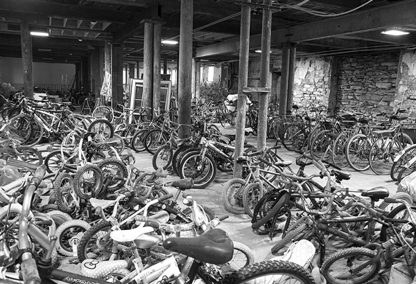 Dozens of cast-off bicycles are gathered in one room at the Old Stone Mill Center for Arts and Creative Engineering. After repairs and modifications, most will be shipped to countries in Africa to provide basic transportation. Susan Sabino photo