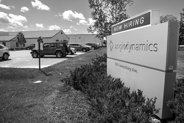 The sign outside AngioDynamics' medical device plant in Queensbury, N.Y., says the company is now hiring, but the factory is set to shut down at the end of 2025. Employee shortages are one reason the company has cited for its decision to close its local plants and outsource all of its manufacturing. All photos by Joan K. Lentini.