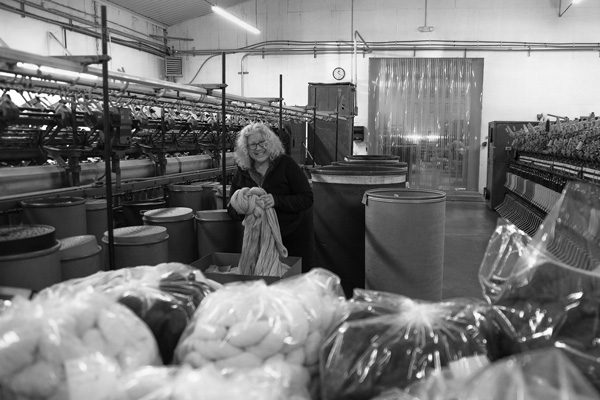 Mary Jeanne Packer, the founder and co-owner of the Battenkill Fibers mill in Greenwich, NY., checks through some of the yarn the mill makes from locally raised wool. Joan K. Lentini photo