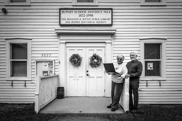 Arlene Bentley and Bill Meyer stand with a laptop computer outside the Rosalind K. Kittay Public Library in Rupert, Vt. The local library is the only WiFi hotspot in the rural town, where most residents can’t get high-speed Internet service at home. Joan K. Lentini photo