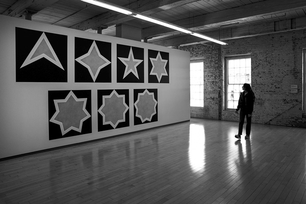 Anais Velorme of Quebec strolls through part of the Sol Lewitt exhibit “A Wall Drawing Retrospective” at Mass MoCA. The show comprises 105 of Lewitt’s large-scale wall drawings, which together cover nearly an acre of space in three stories of the museum’s Building No. 7. Joan K. Lentini photo