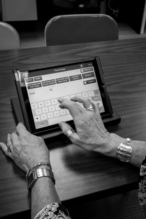 Warren County elections officials demonstrate one of the county’s new electronic poll books. Voters use the device to sign in before casting ballots at the county’s early voting site. Joan K. Lentini photo